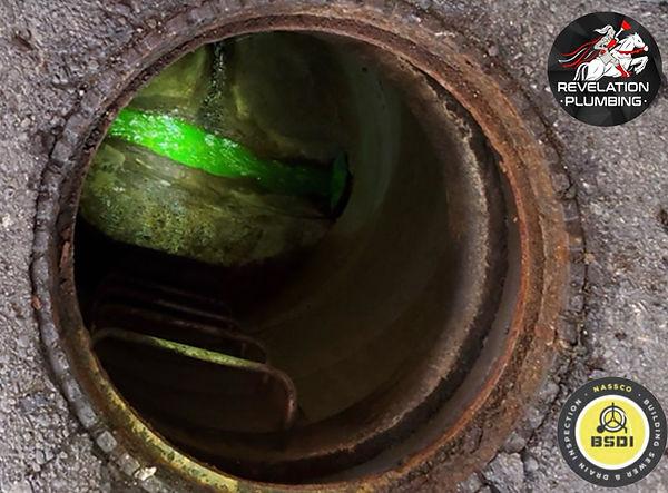 Green dye visible inside a sewer line during a camera inspection